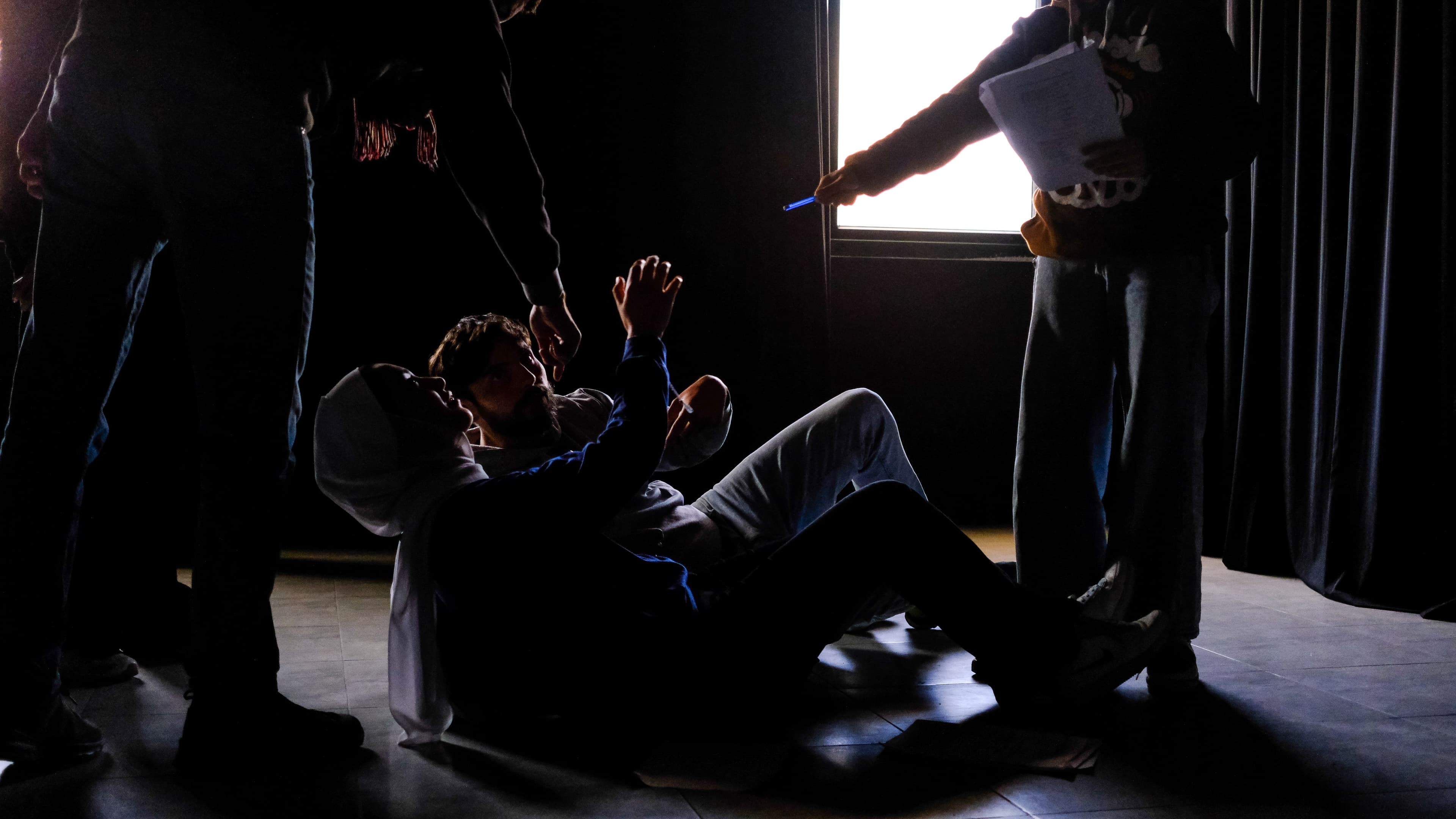 Actor in silhouette under blue stage light